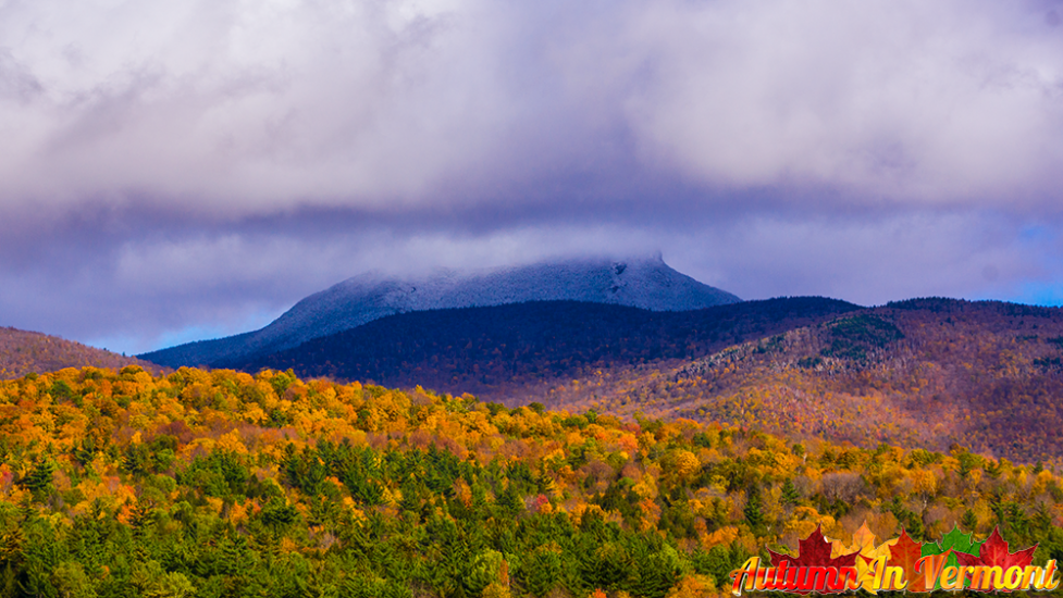 Autumn on with snow on  Camels Hump.